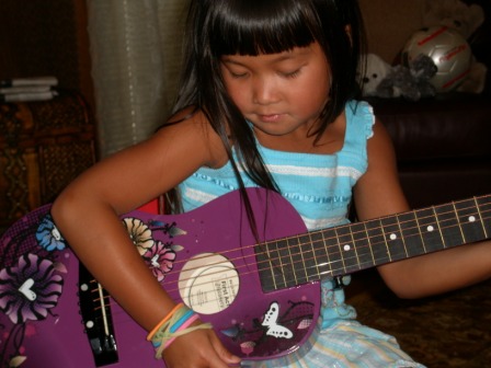 Kasen playing guitar